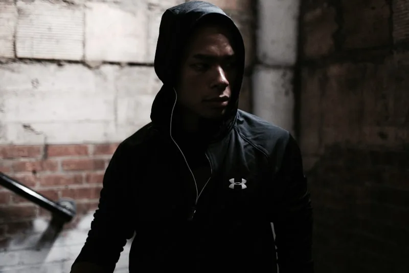 Person wearing a compression hoodie during workout or athletic activity