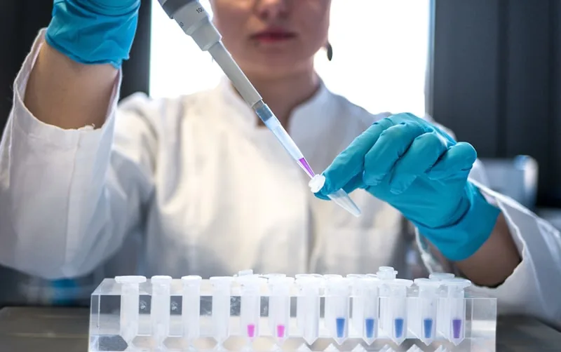 Researcher or technician carefully evaluating and testing scientific measurement instruments in a lab environment