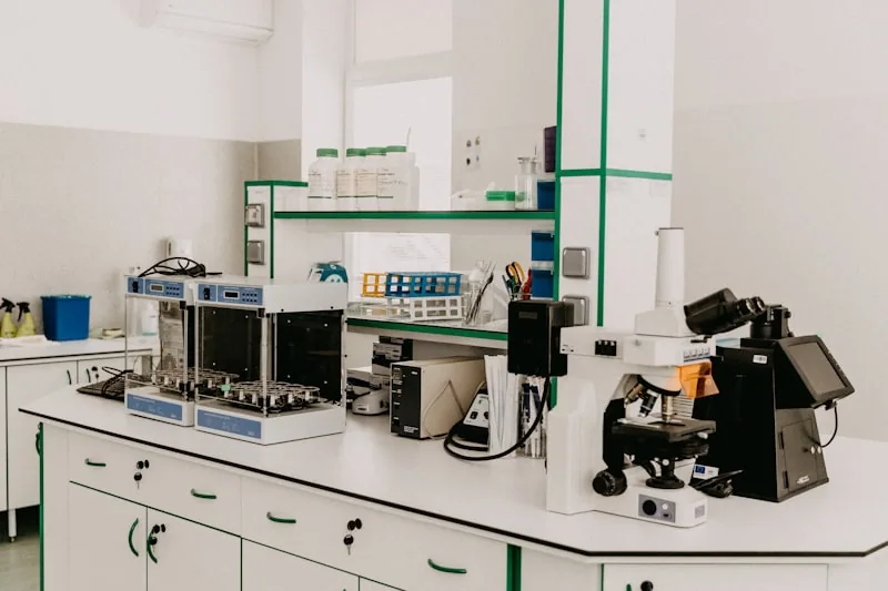Scientist conducting tests in a laboratory with beakers and testing equipment